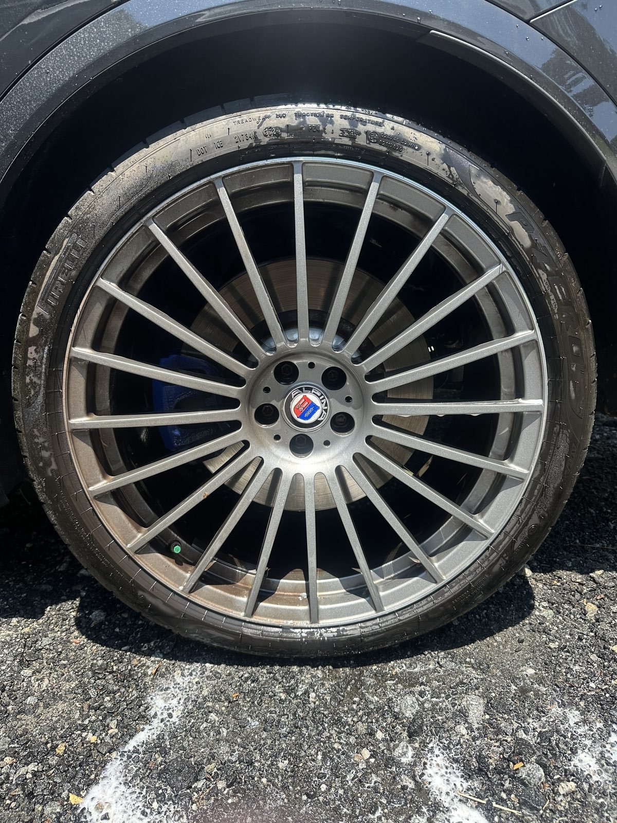 Wheel shown half dirty and half clean demonstrating Zane's Detailing results